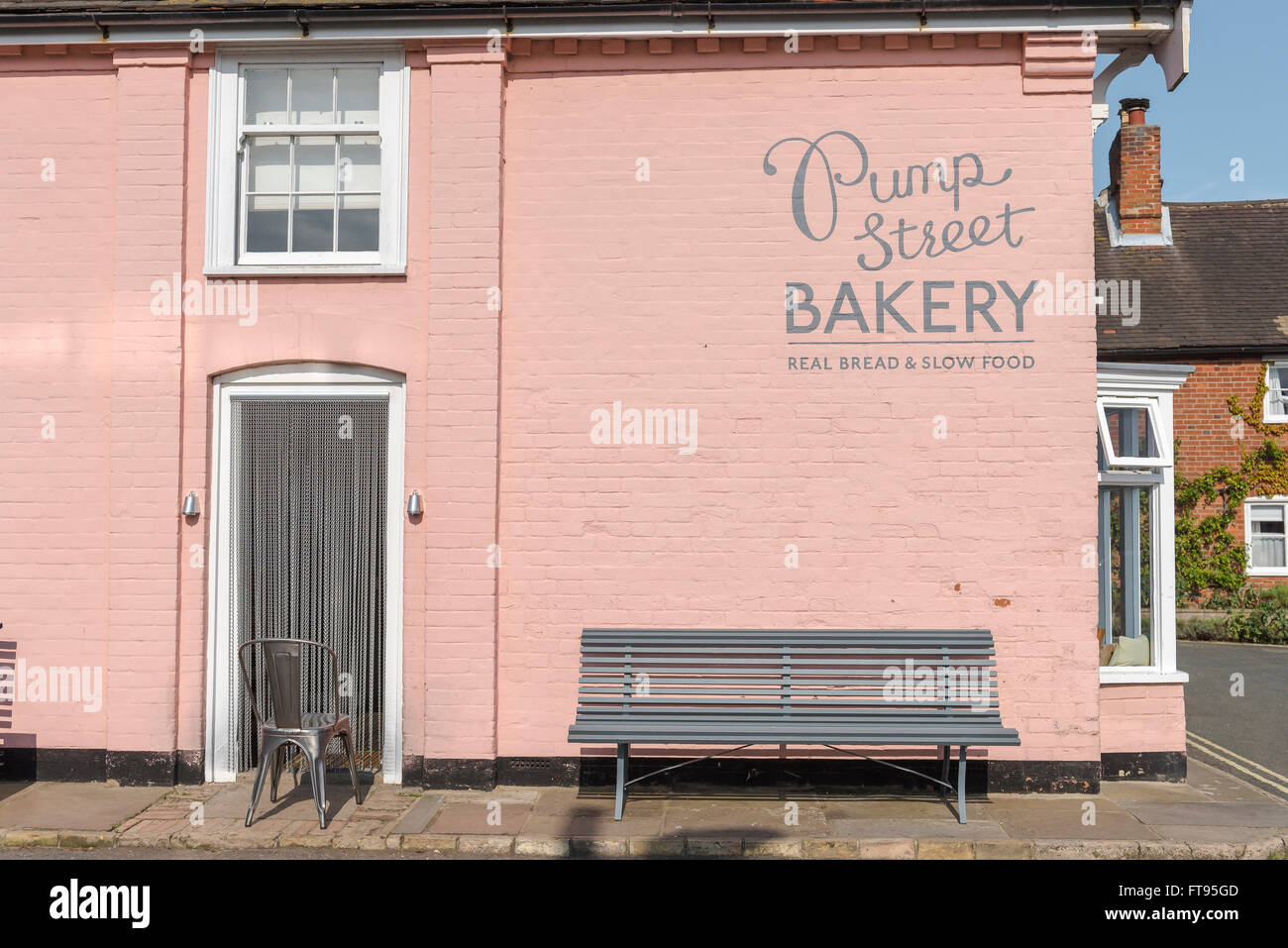 Pump Street Bakery, view of the pink wall and signage alongside the popular Pump Street Bakery in Orford, Suffolk, England. Stock Photo