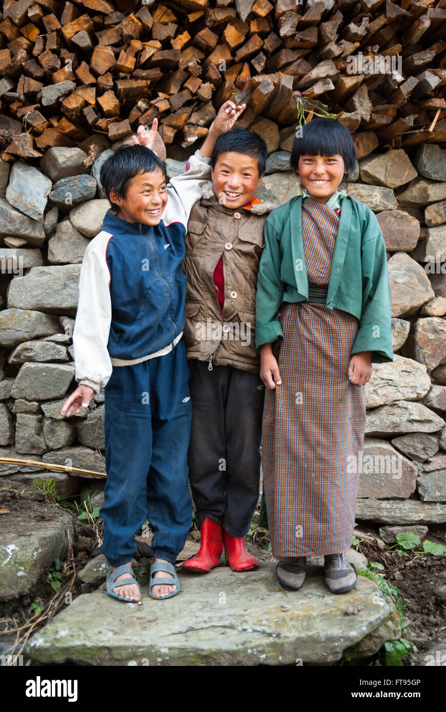 Three young Bhutanese children in Gophu Village, Phobjikha Valley, Bhutan Stock Photo