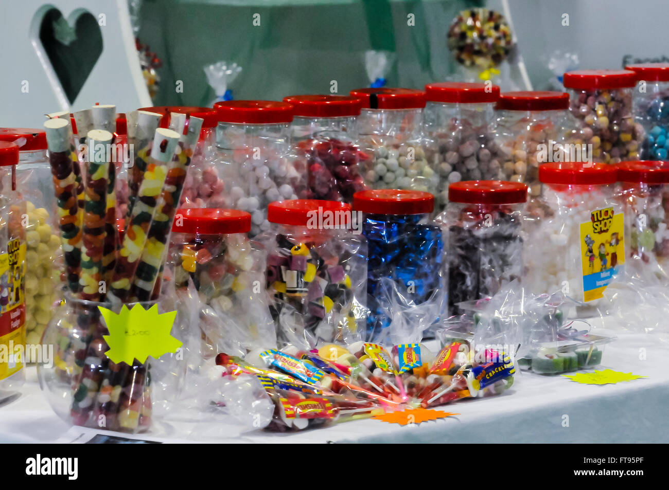 Large jars of sweets for sale at a market stall. Stock Photo