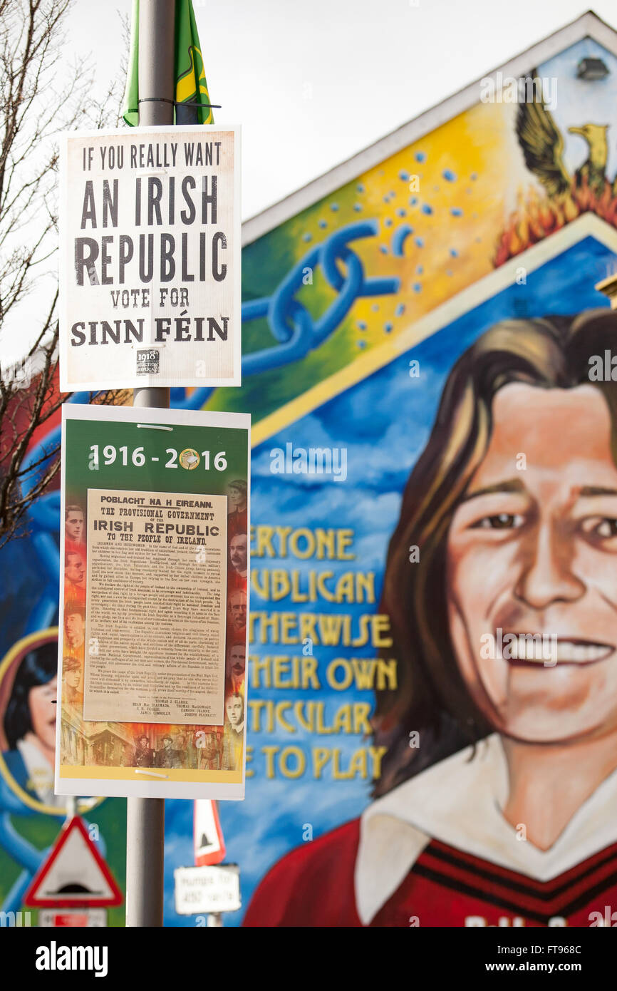 West Belfast, Ireland. 25th March, 2016. Sinn Fein posters with the proclamation of Ireland attached to a lamppost in West Belfast. with a mural of Bobby Sands in the background this is in Preparation for the Commemoration of the 100th Anniversary of the Easter Rising Credit:  Bonzo/Alamy Live News Stock Photo
