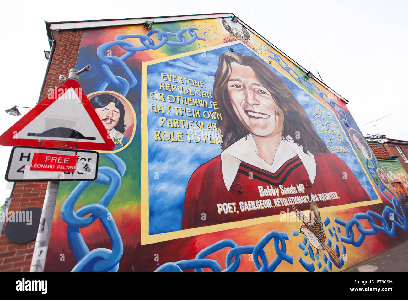 West Belfast, Ireland. 25th March, 2016. A 'Free Leonard Peltier' attached to a lamppost in West Belfast. with a mural of Bobby Sands in the background this is in Preparation for the Commemoration of the 100th Anniversary of the Easter Rising Credit:  Bonzo/Alamy Live News Stock Photo