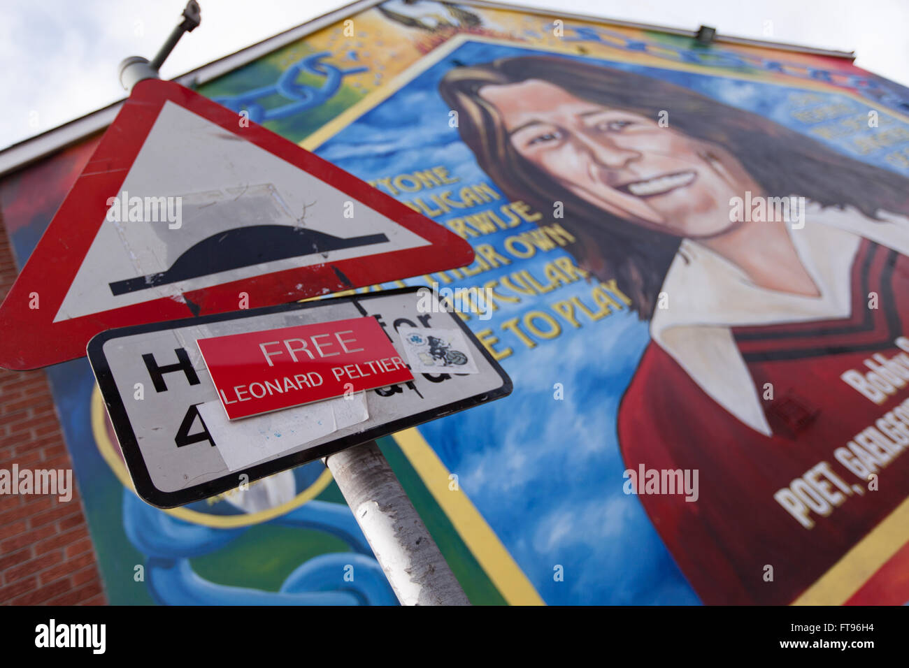 West Belfast, Ireland. 25th March, 2016. A free Leonard Peltier attached to a lampost in West Belfast. with a mural of Bobby Sands in the background this is in Preparation for the Commemoration of the 100th Anniversary of the Easter Rising Credit:  Bonzo/Alamy Live News Stock Photo