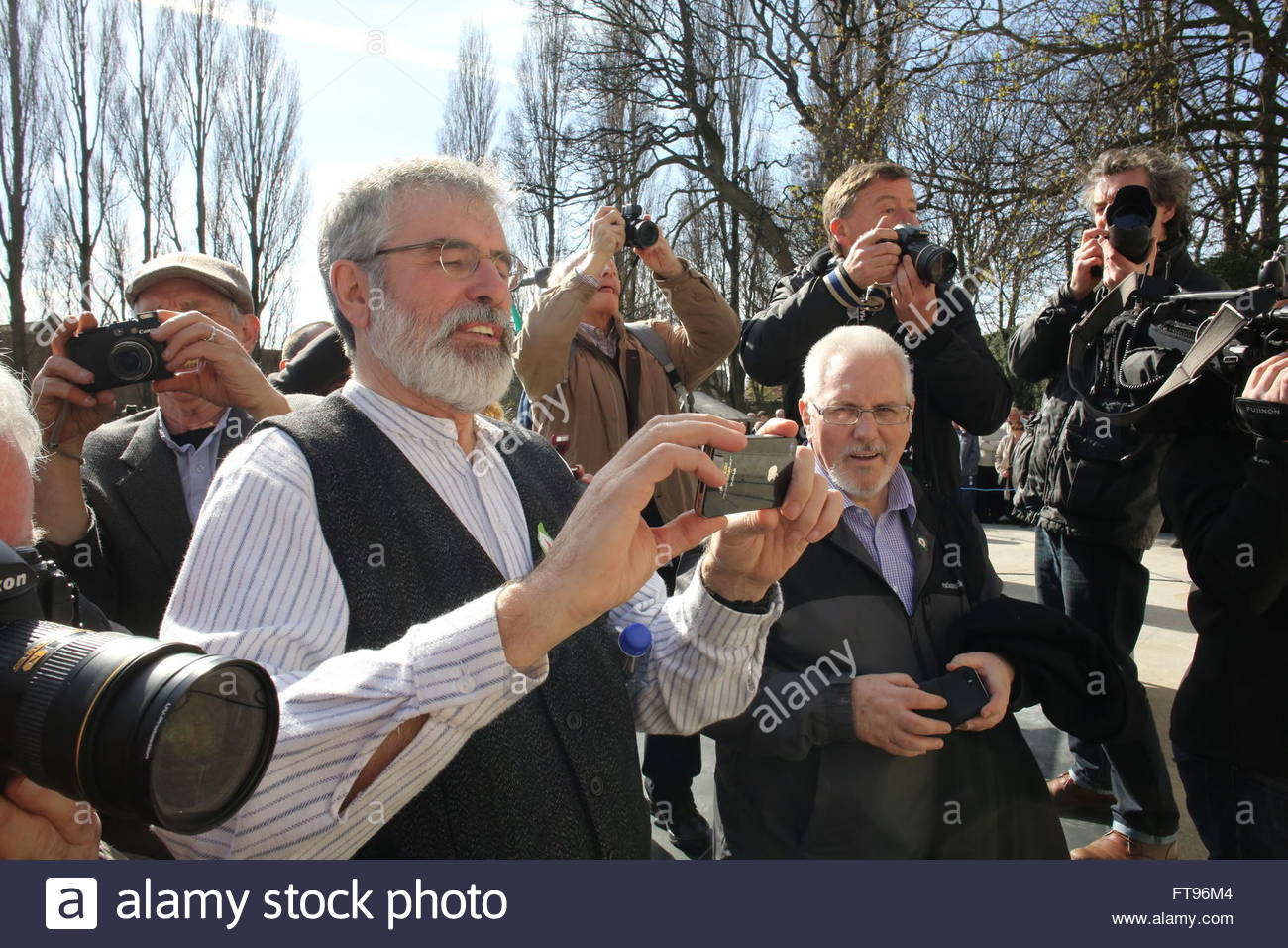 Dublin, Ireland. 25th March, 2016. Gerry Adams takes a photo among a mass of photographers at Arbor Hill this afternoon before the 1916 centenary event. Credit:  reallifephotos/Alamy Live News Stock Photo