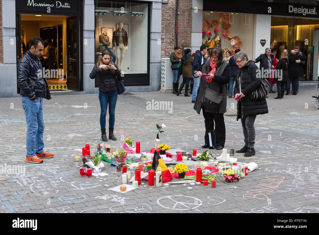 Namur, Belgium. 25 Mar, 2016. Bystanders look at the messages and candle that were posted during the Tribute to the victims of March 22nd terrorist attacks on Brussels in Namur, Belgium. Credit:  Frédéric de Laminne/Alamy Live News Stock Photo