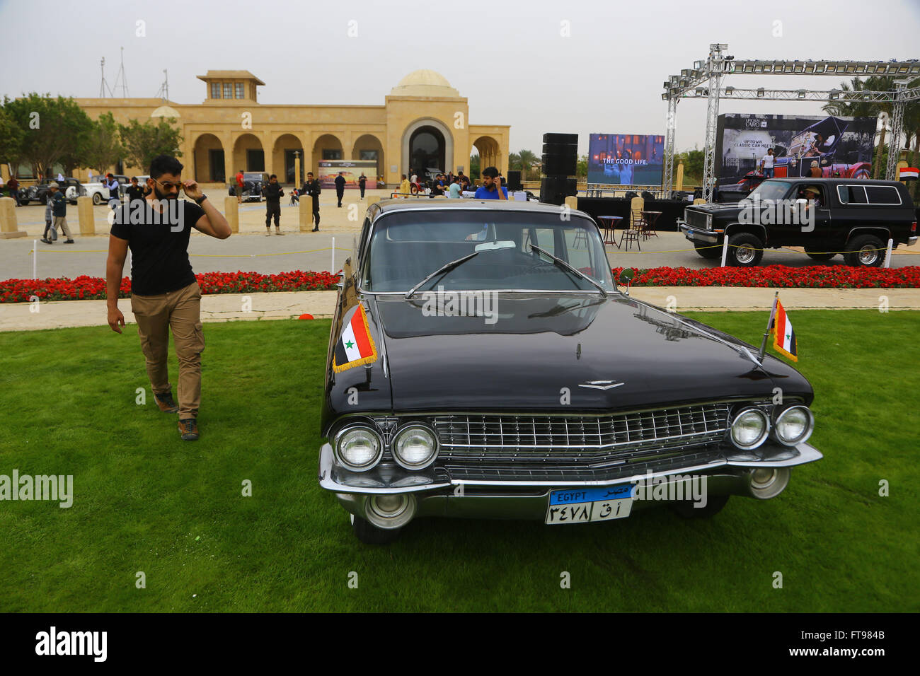 Cairo, Egypt. 25th Mar, 2016. A man walks past the car previously owned