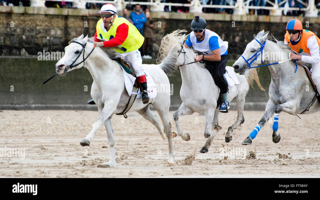 Ribadesella, Spain. 25th March, 2016. Luis Hermido Martinez with 'Xas' and David Blanco with 'Califa' during the second race of horse race at Sta. Marina Beach on March 25, 2016 in Ribadesella, Spain. Credit:  David Gato/Alamy Live News Stock Photo