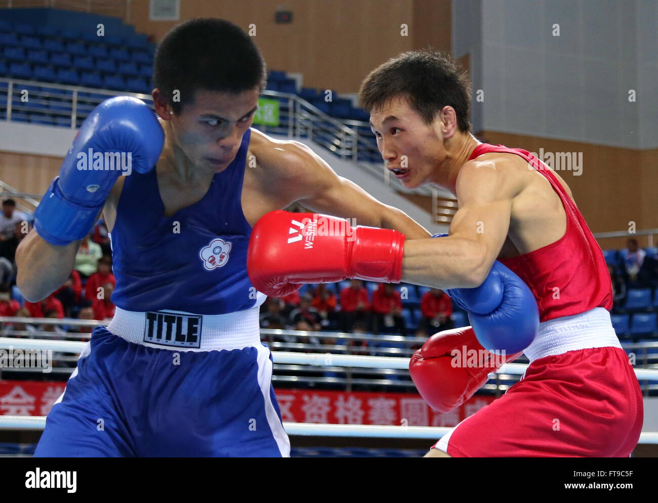 Qian'an, China's Hebei Province. 26th Mar, 2016. Enkh-Amar Kharkhuu(R) of Mongolia competes with Jan Chun-Hsien of Chinese Taipei during their men's 52kg category of Asia/Oceania Zone boxing event qualifier for 2016 Rio Olympic Games in Qian'an, north China's Hebei Province, March 26, 2016. Enkh-Amar Kharkhuu won the match 3-0. Credit:  Yang Shiyao/Xinhua/Alamy Live News Stock Photo