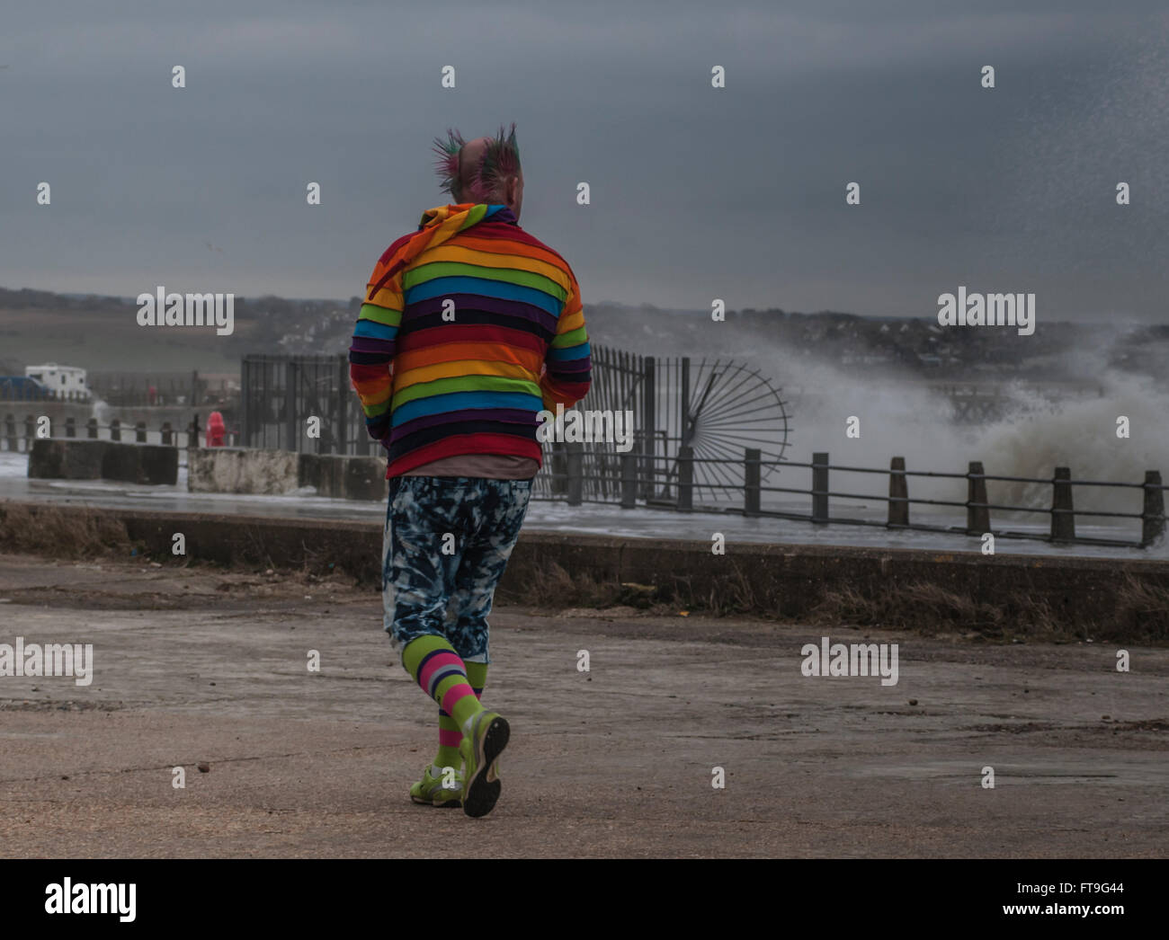 Newhaven, East Sussex, UK.26 March 2016.Storm force wind from the South whips up the sea in harbour entrance. Colourful character brightens the scene . Stock Photo
