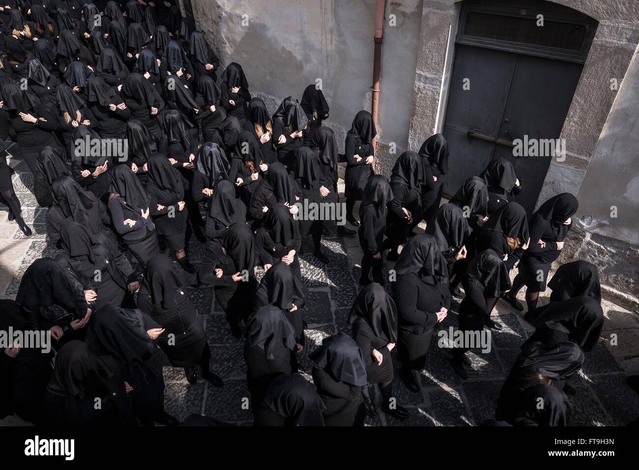 Canosa Di Puglia, Italy. 26th Mar, 2016. On the Holy Saturday, during the week of Easter, takes place in Canosa di Puglia (Province of Barletta-Andria-Trani), the procession of the Desolata (Our Lady of Sorrows). The statue of the Virgin is followed by a group of about three hundred and fifty girls, totally dressed in black and with their face covered by a black veil, who sing the heartbreaking song by the name of 'Hymn of the Desolate'. Credit:  Michele Amoruso/Pacific Press/Alamy Live News Stock Photo