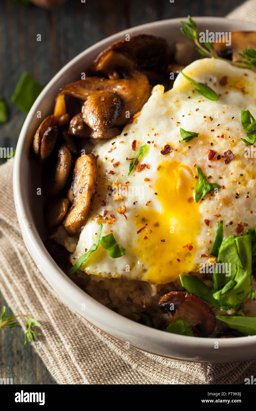 Healthy Homemade Savory Oatmeal with Eggs Mushrooms and Spinach Stock Photo