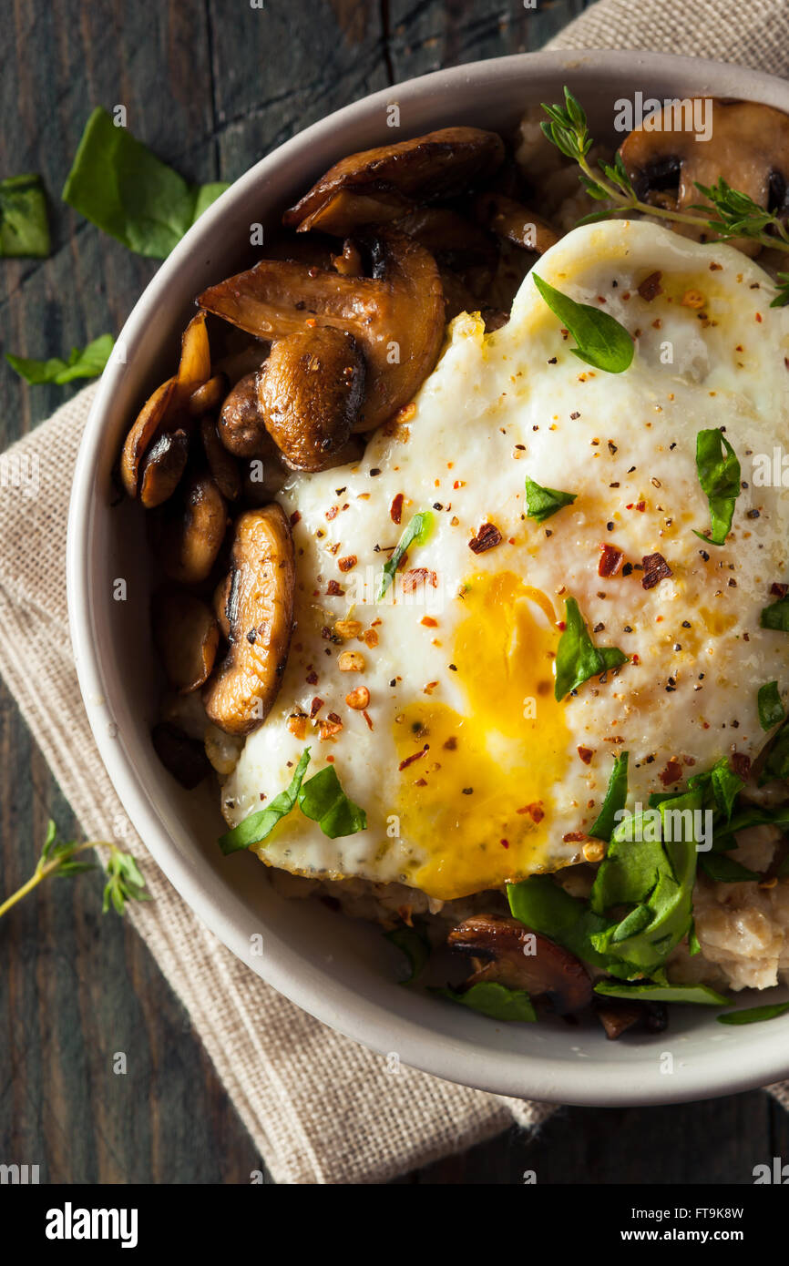 Healthy Homemade Savory Oatmeal with Eggs Mushrooms and Spinach Stock Photo
