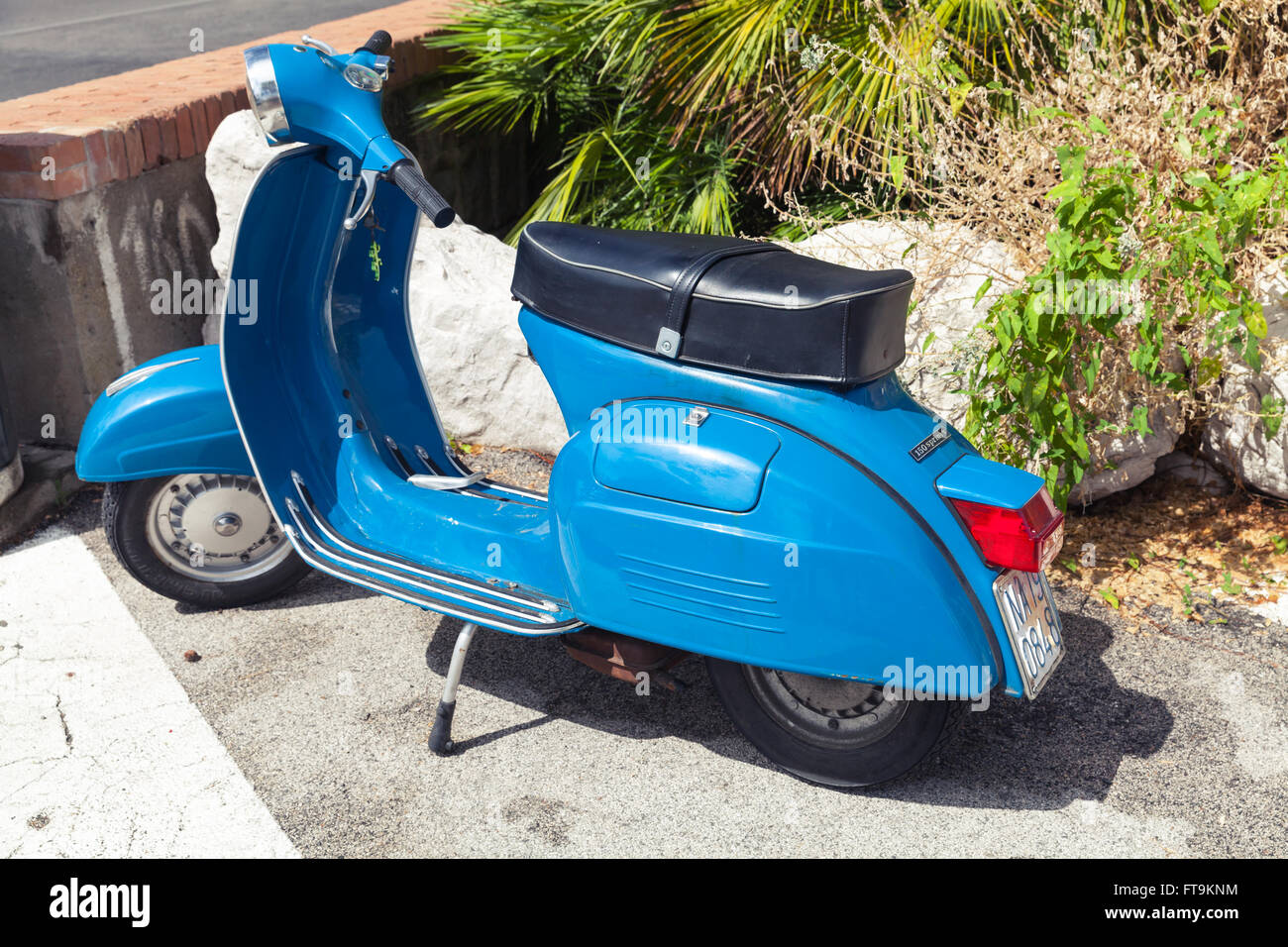 Lacco Ameno, Italy - August 11, 2015: Classic blue Vespa Sprint 150 scooter stands parked in a town Stock Photo