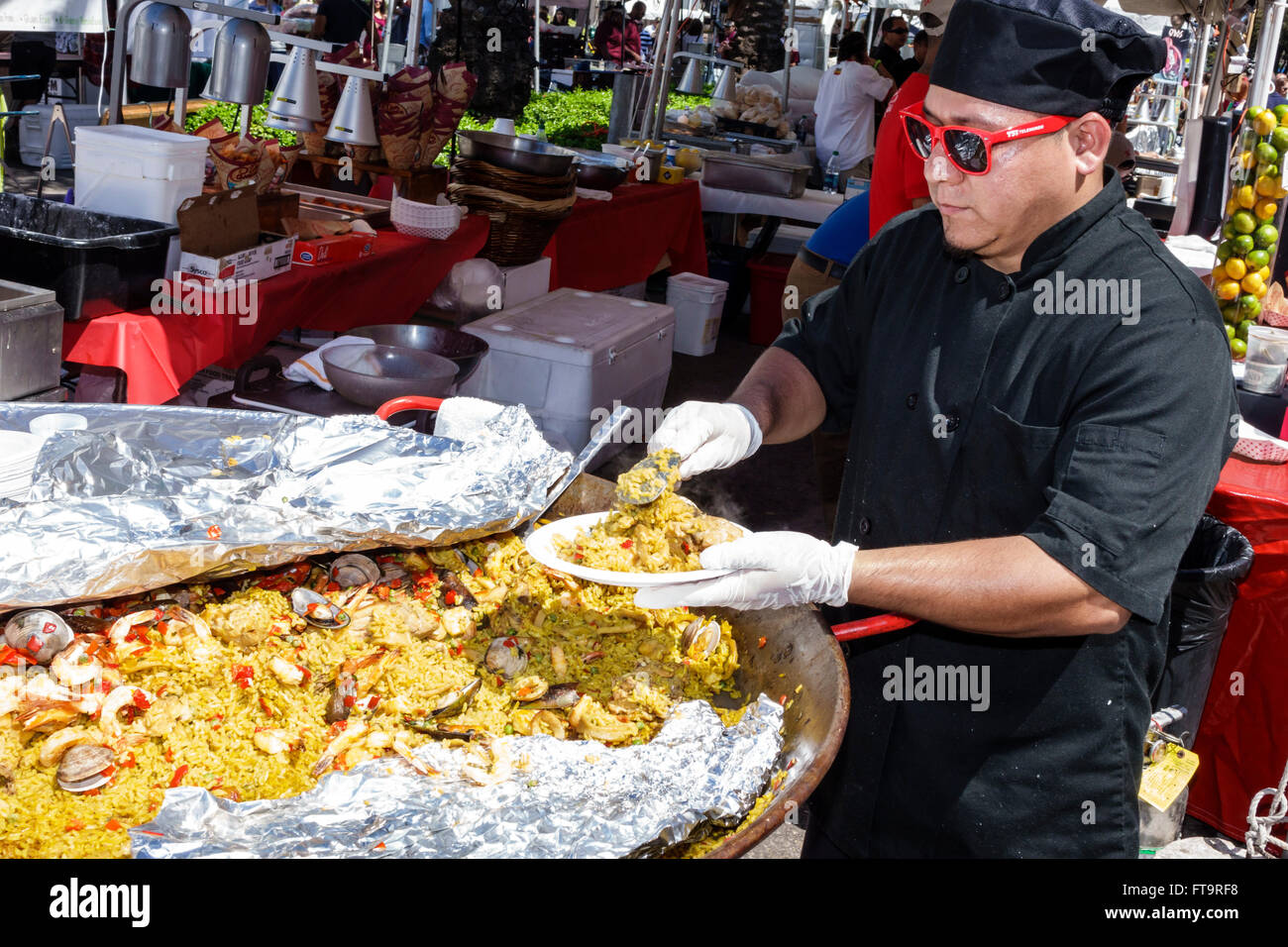 Miami Florida,Coral Gables,Carnaval Carnival Miracle Mile,street festival,annual celebration,Hispanic ethnic adult,adults,man men male,cook,chef,stall Stock Photo