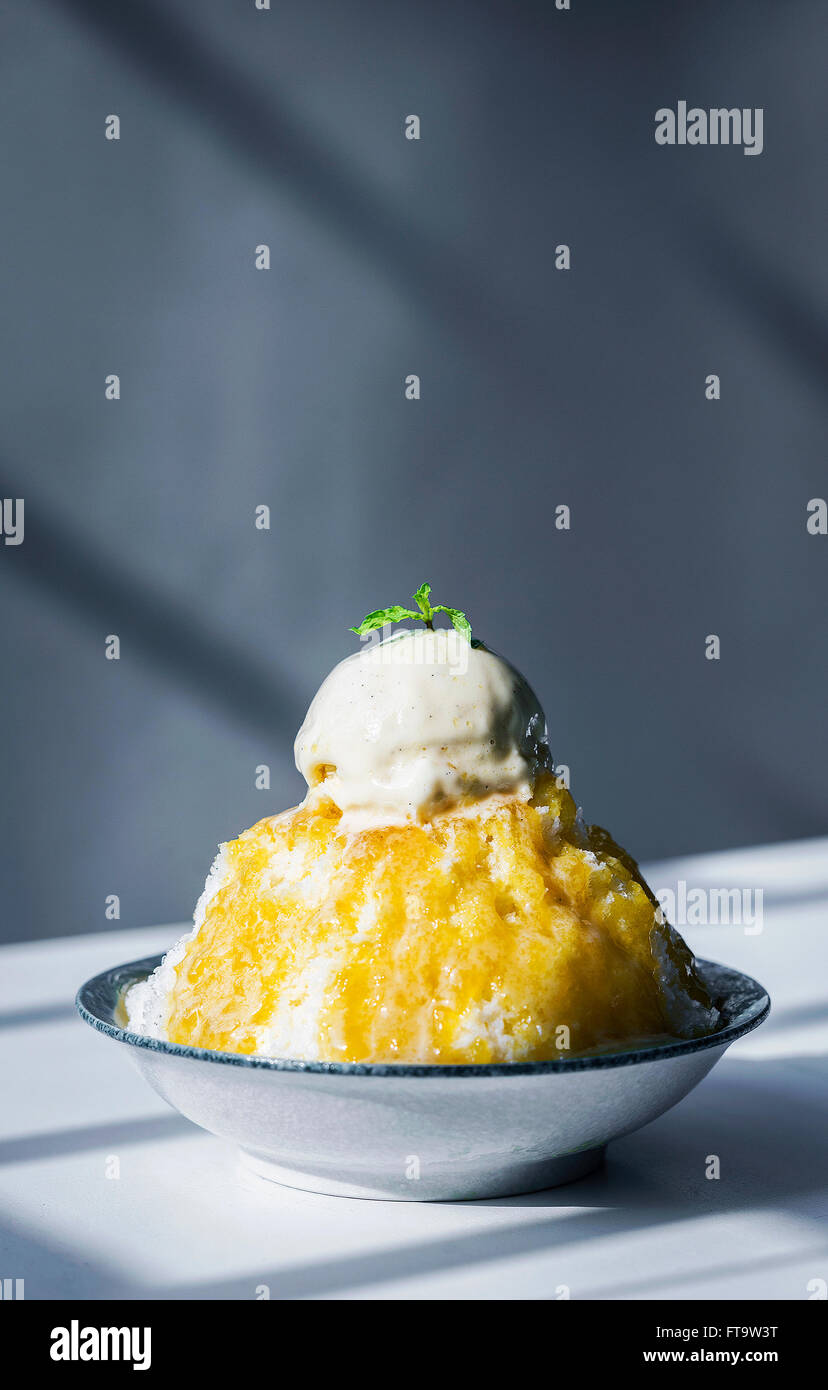 coconut sorbet with mango coulis sauce and vanilla ice cream Stock