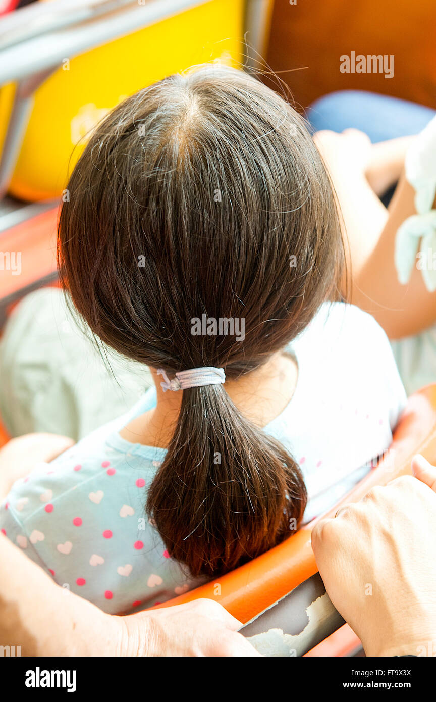 Pretty Asian Thai girl looking out with hair accessories on a river cruise on the Chao Phraya River in Bangkok,Thailand. Stock Photo
