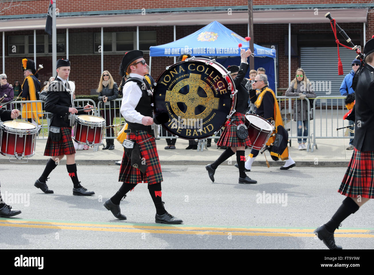 Iona College Pipes and Drums band marching in St. Patrick's Day parade Yonkers New York Stock Photo