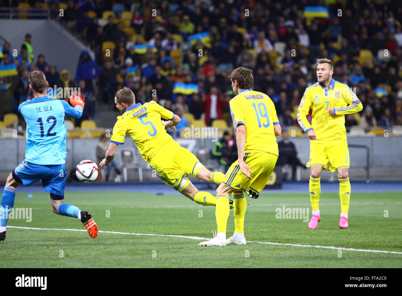 KYIV, UKRAINE - OCTOBER 12, 2015: Ukrainian footballers (in yellow) attack goalkeeper David de Gea of Spain during their UEFA EU Stock Photo