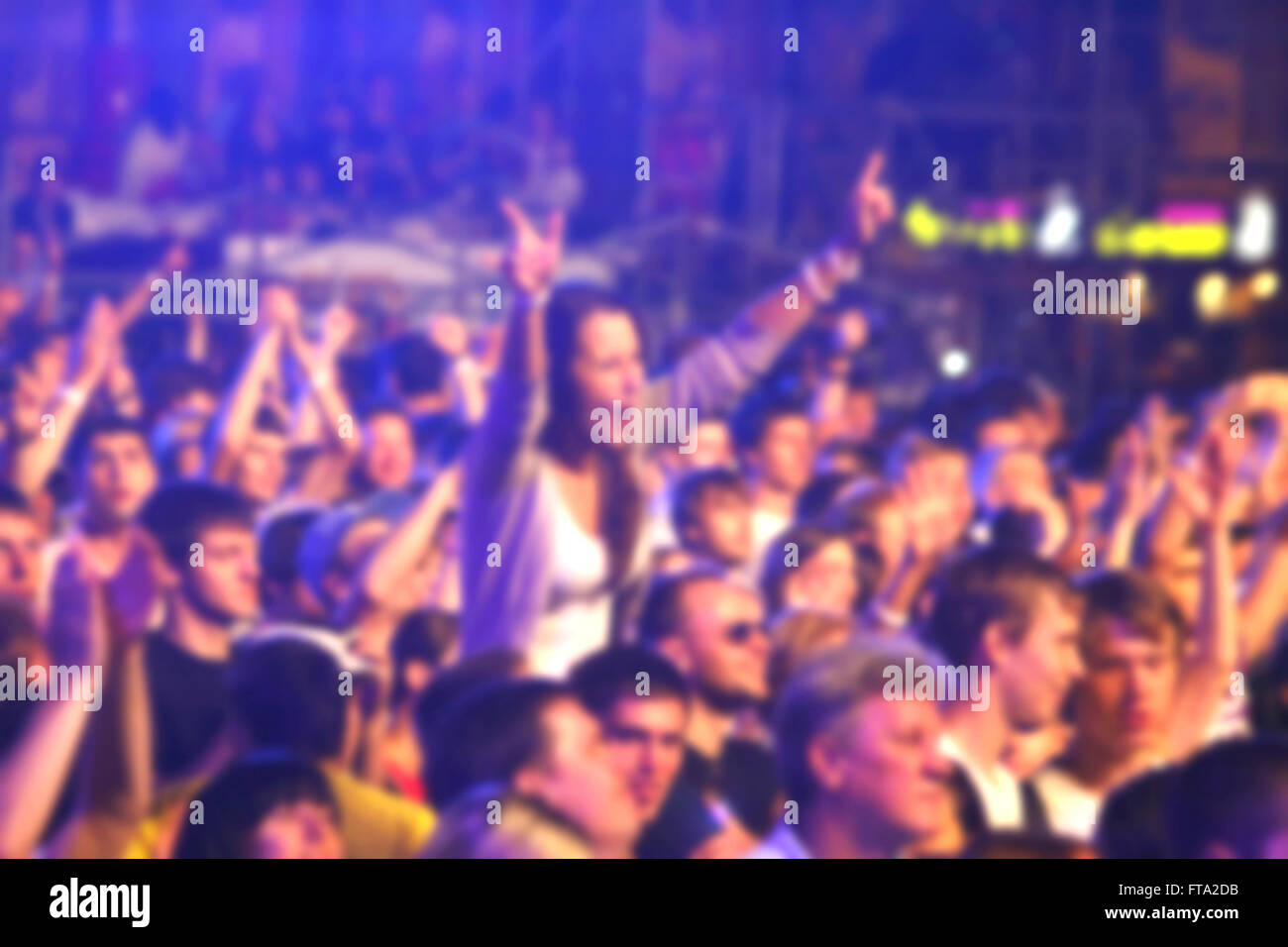 Blurred unrecognizable people dance during rock concert Stock Photo