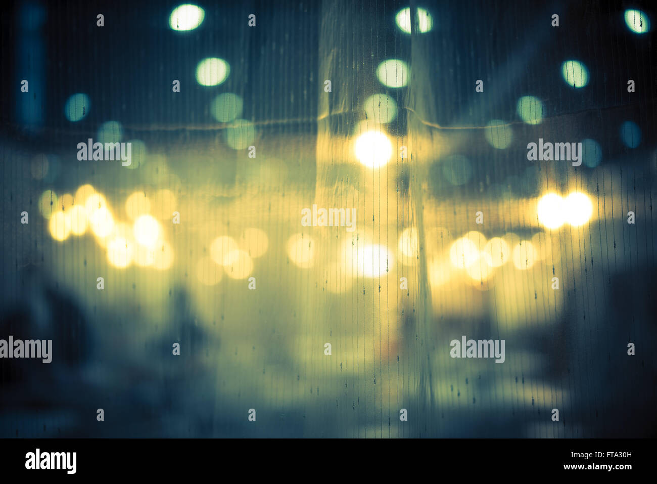 Dark and vintage abstract background of night bokeh through light curtain Stock Photo