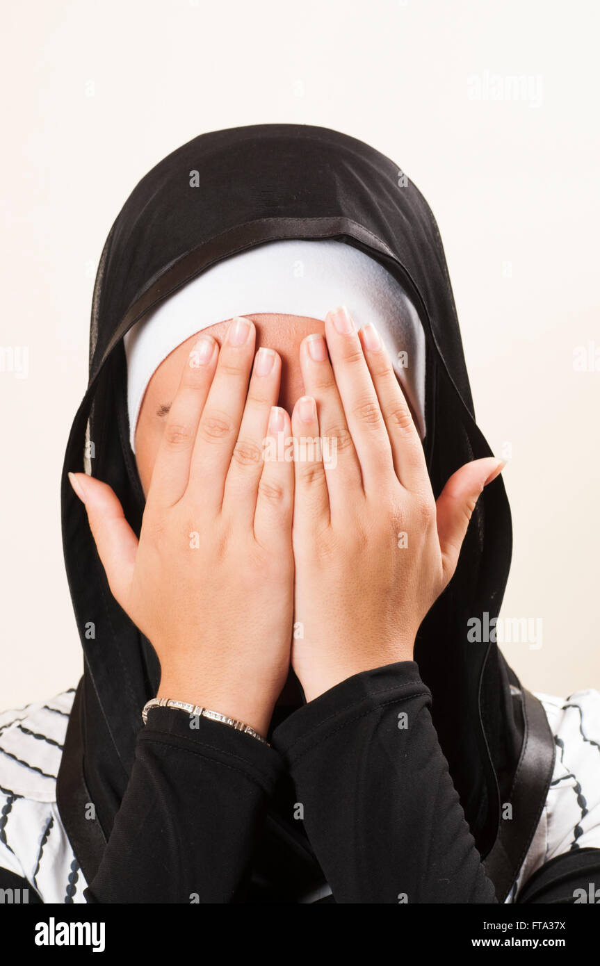 Muslim woman hiding face hands hi-res stock photography and images - Alamy