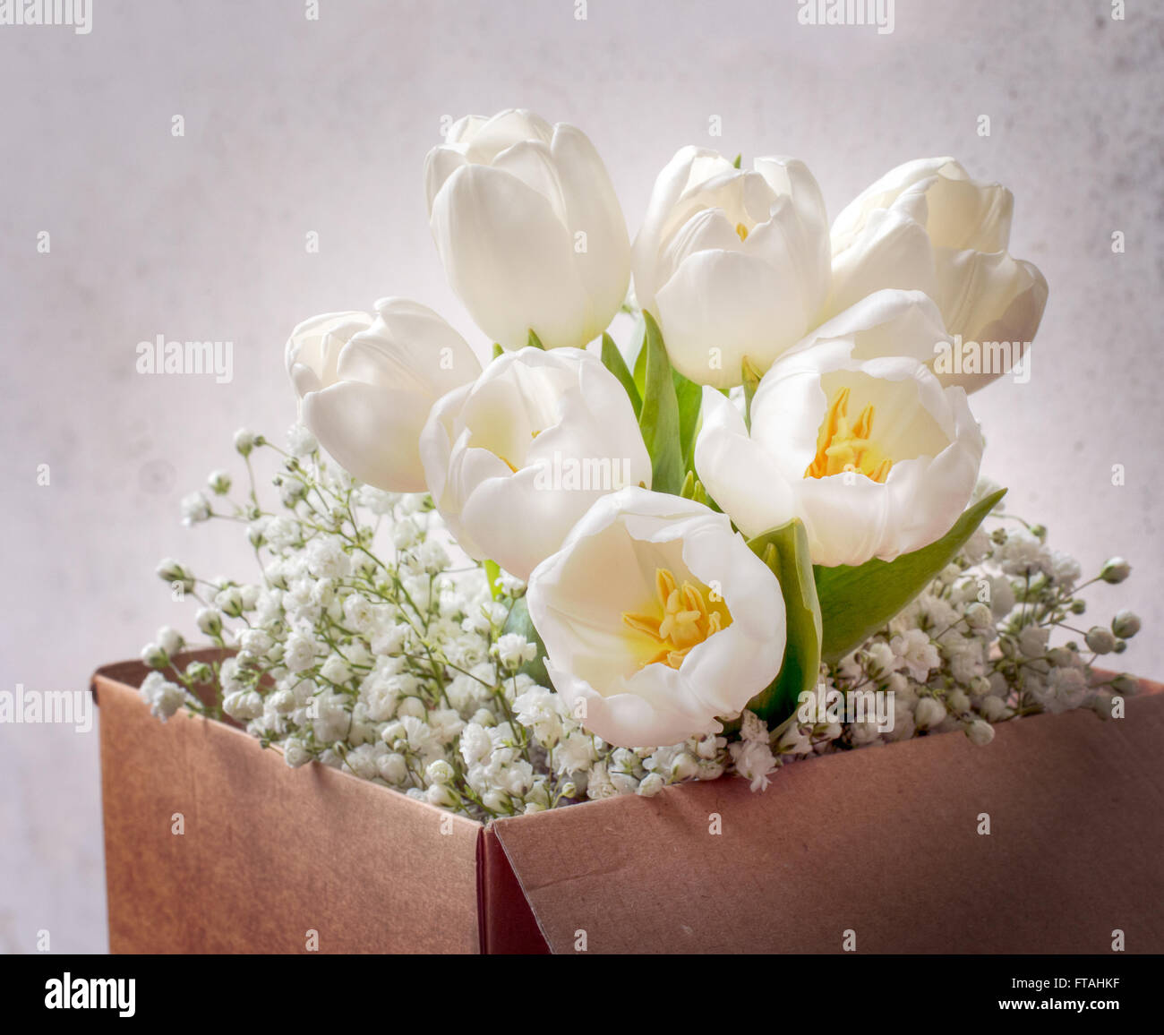 Beautiful spring flowers. Shabby chic in cardboard box. Stock Photo