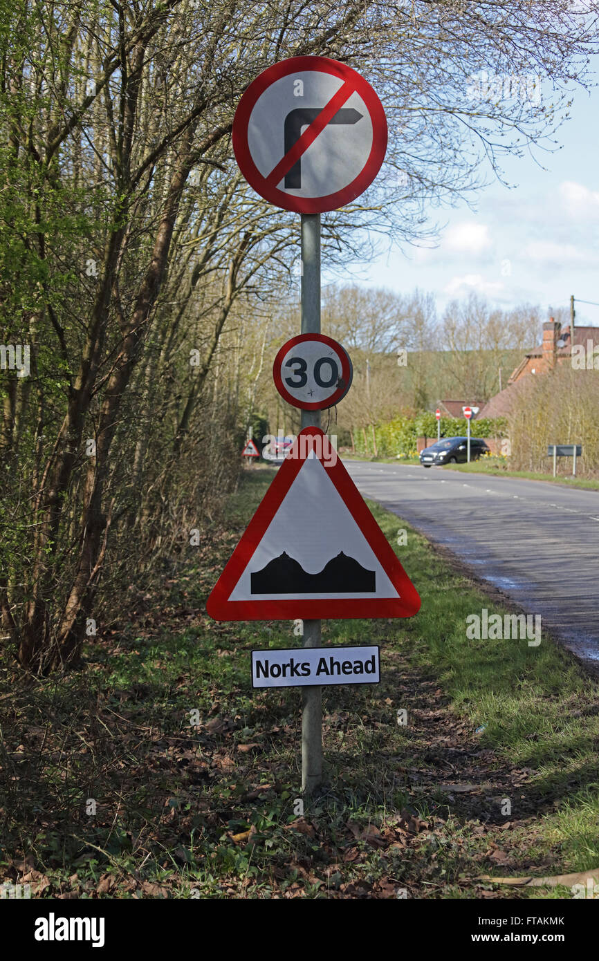 The local 'wags' strike again with a professionally made road sign attached under the official one which has been modified. Stock Photo