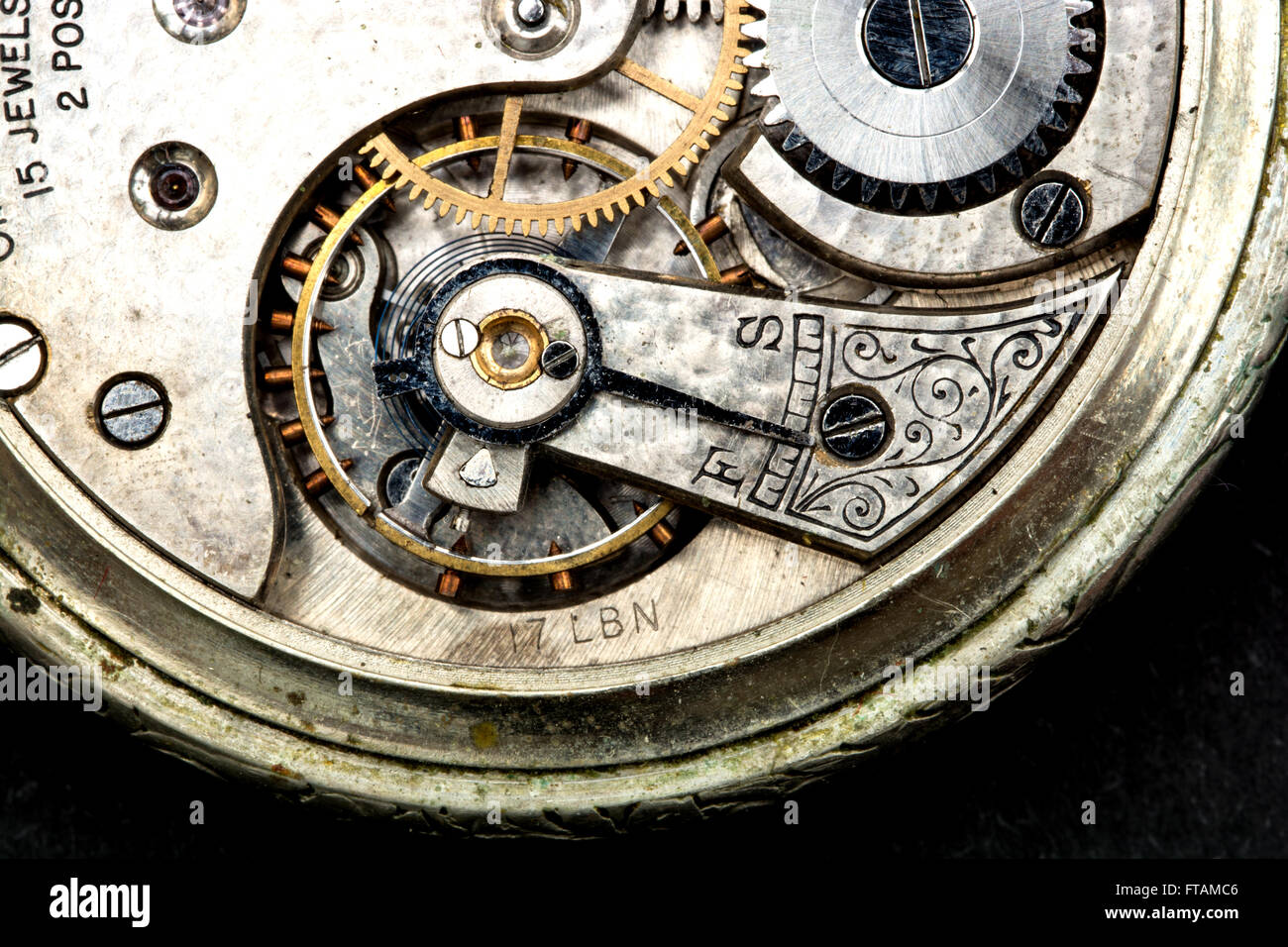 Inside workings of old pocket watch on a black background Stock Photo