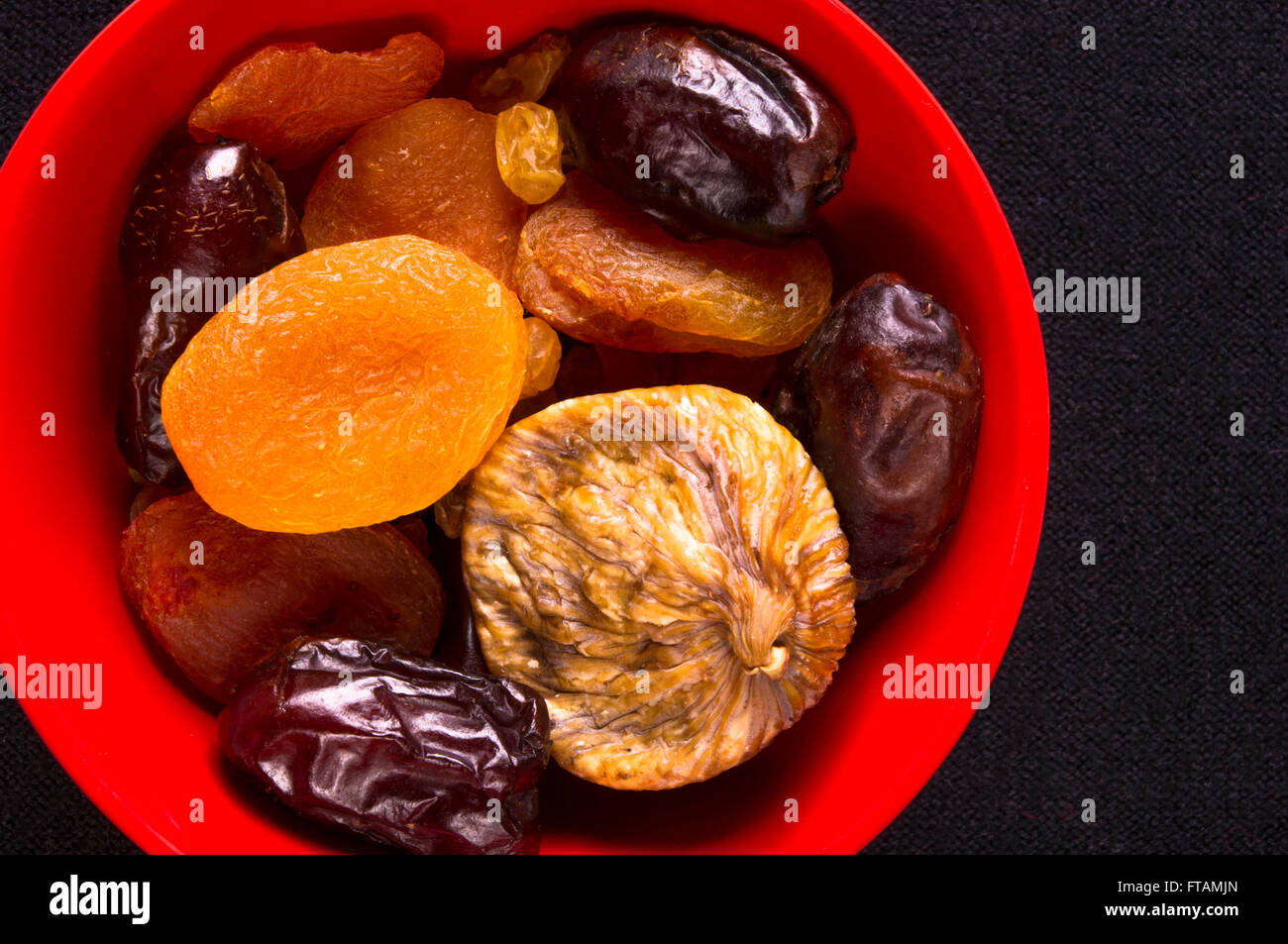 various dried fruits on the black background Stock Photo - Alamy