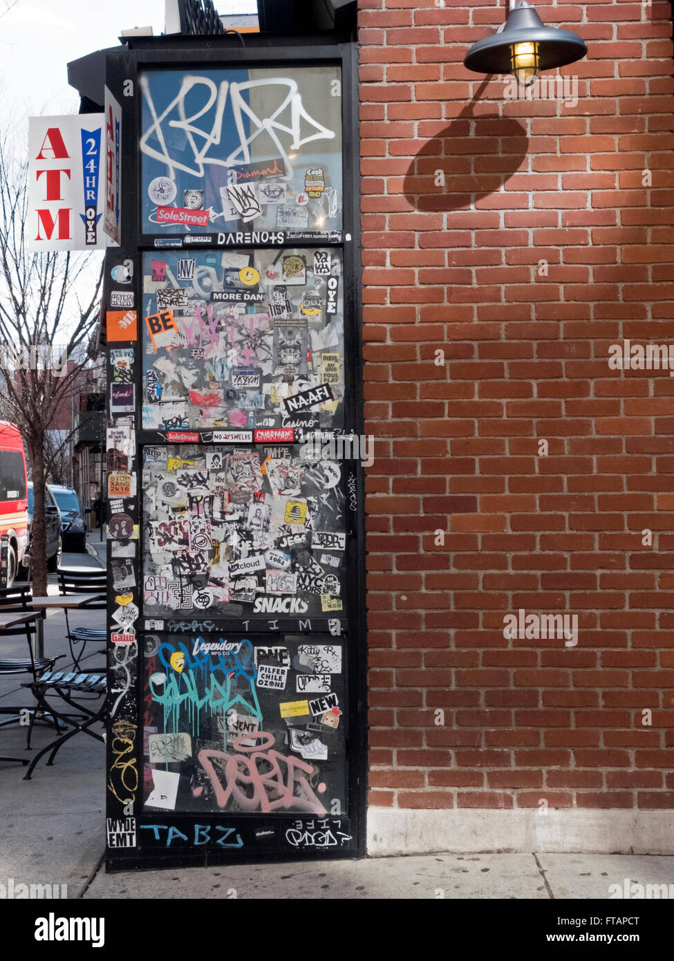 Sticker & tags at the entrance to the Soho Park Cafe on Spring & Lafayette streets in Lower Manhattan, New York City Stock Photo