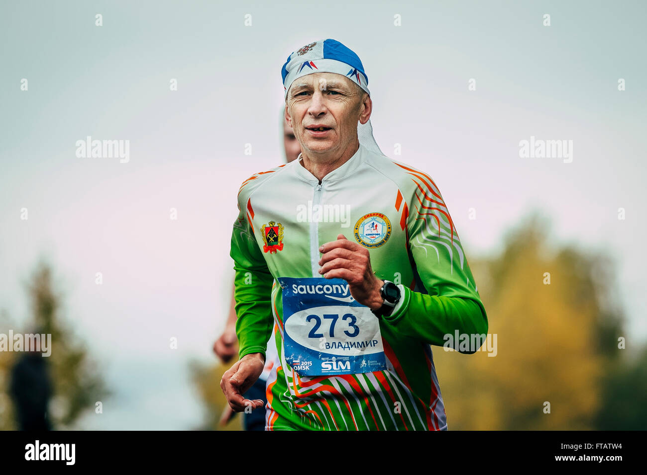 Omsk, Russia -  September 20, 2015: athlete runner running middle-aged by distance during Siberian international marathon Stock Photo