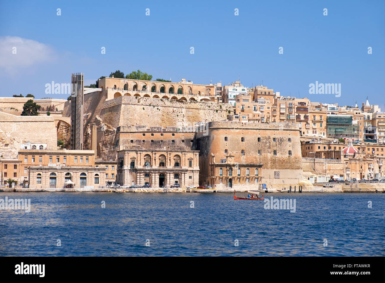 The view of Valletta capital city fortifications with Fort Lascaris and Upper and Lower Barrakka Gardens  from the water of Gran Stock Photo