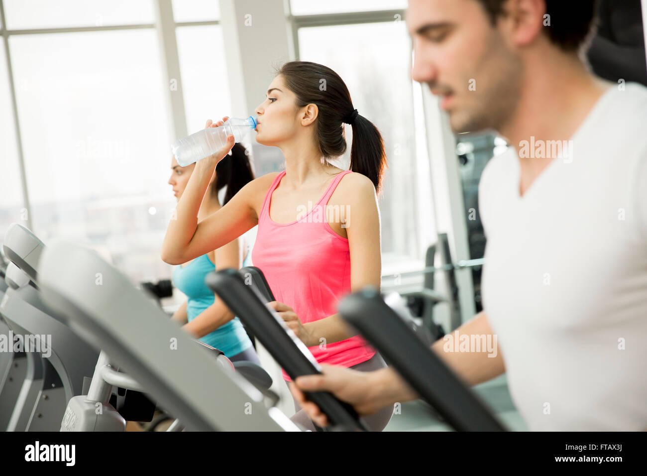 Woman training and drinking water in the gym Stock Photo - Alamy