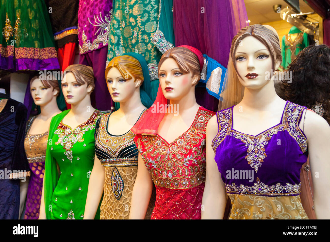 Shop mannequins in Indian dresses and saris in retail display Stock