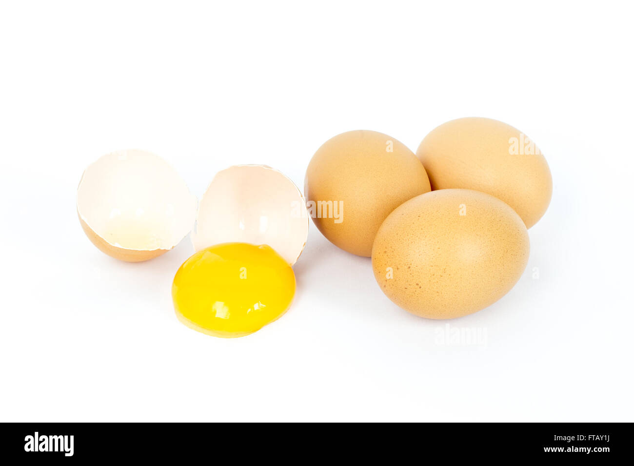Egg in group broken on white background. This picture about food, breakfast or lunch and farm content. Selective focus at yolk. Stock Photo