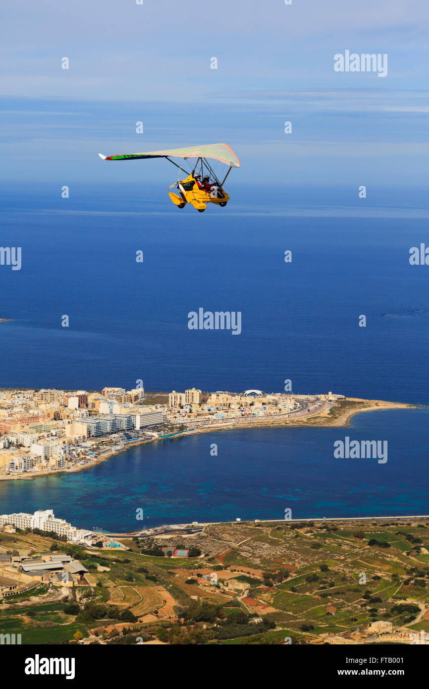 Flexwing microlight over Bugibba and Salina Bay, Malta Stock Photo