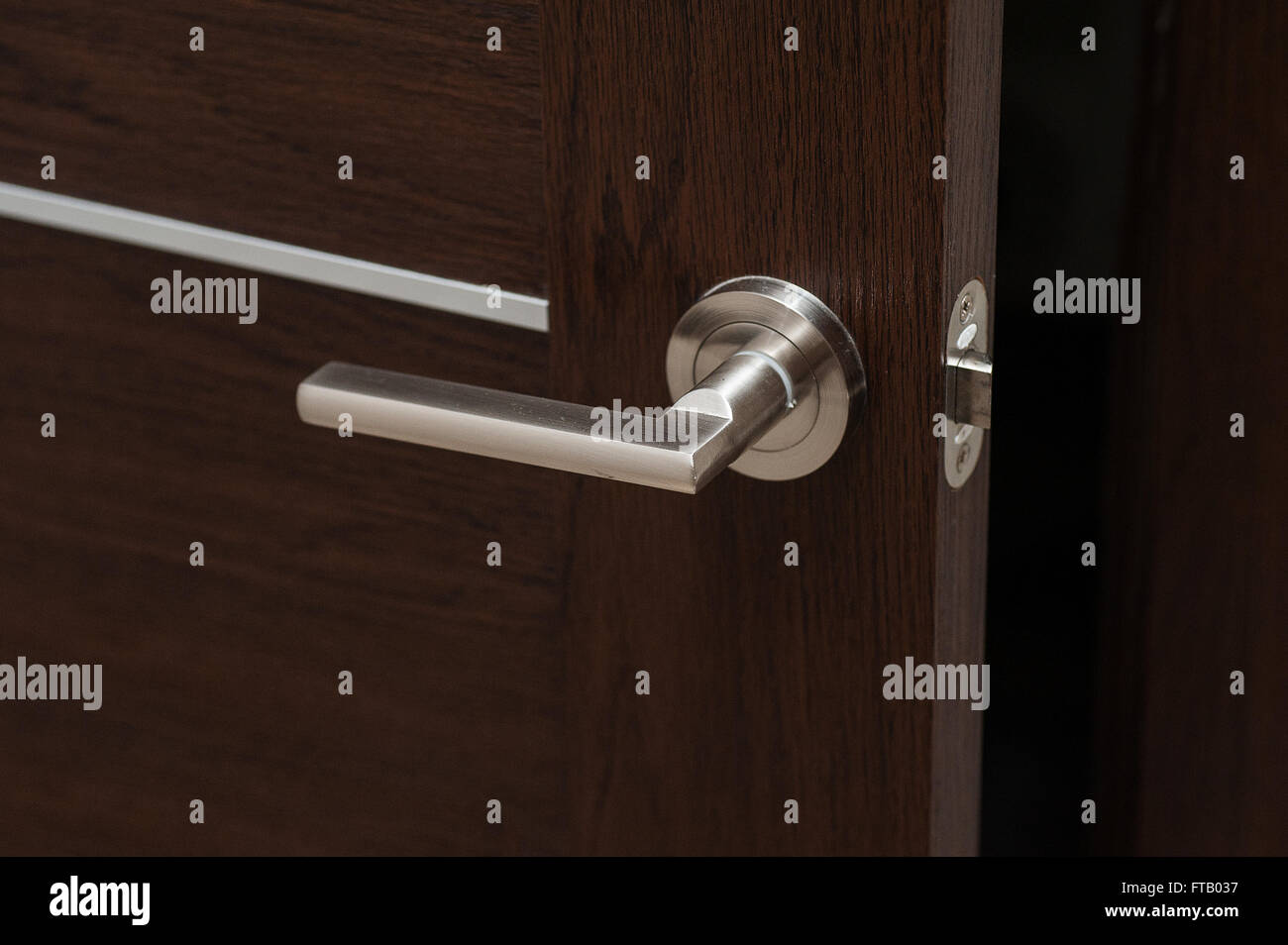 Modern metal door handle in living room Stock Photo Alamy