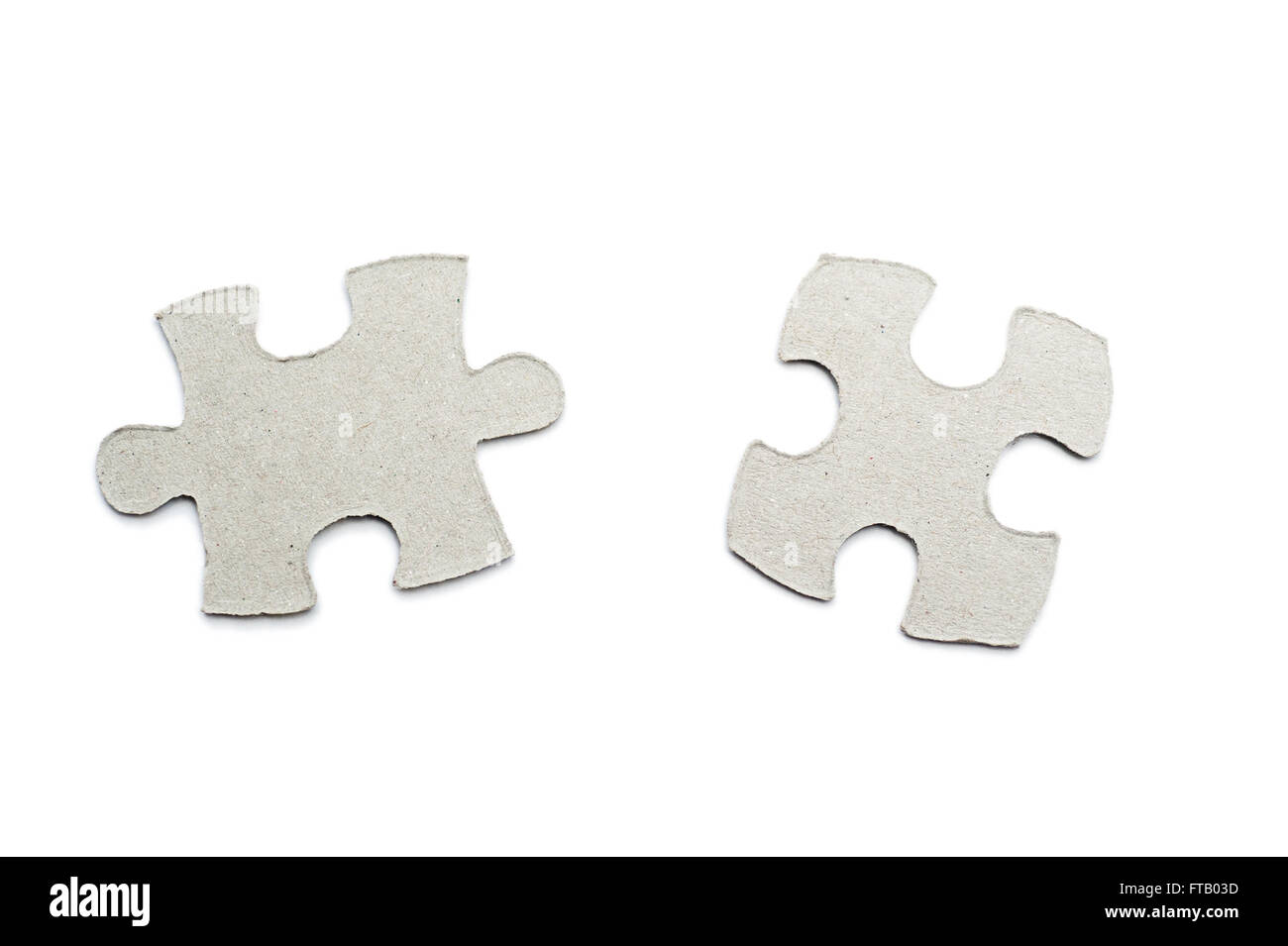 cardboard puzzles pieces on a white background Stock Photo
