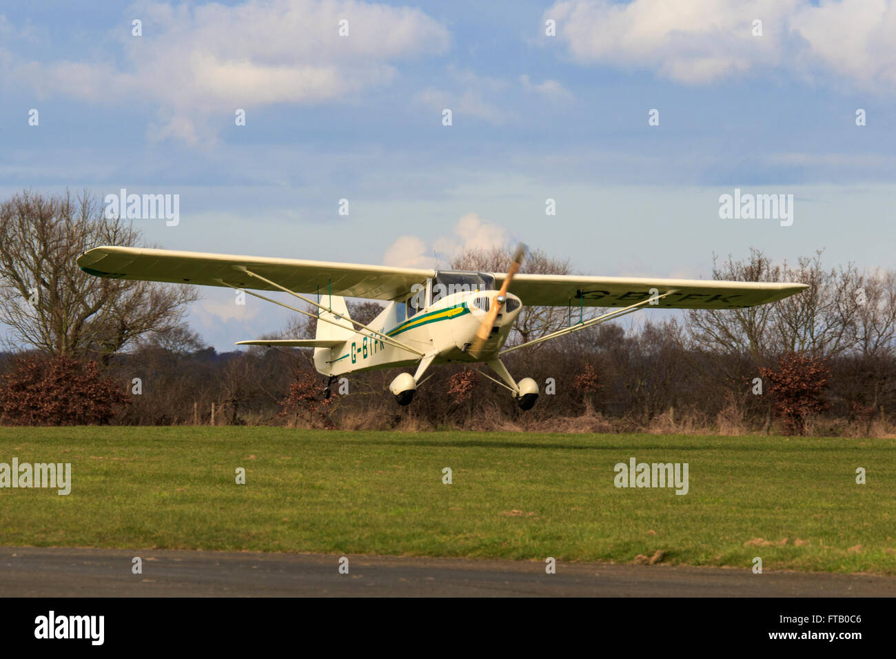 Taylorcraft BC12D Twosome G-BTFK landing at Breighton Airfield Stock Photo