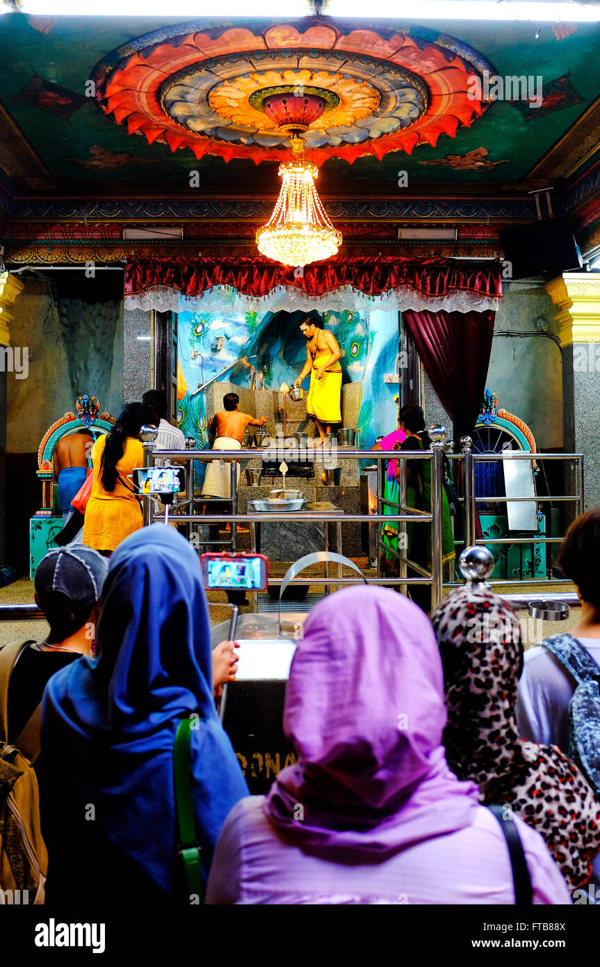 Tourists watching an hindu ceremony in the Batu Caves, Gombak, Selangor, Malaysia Stock Photo