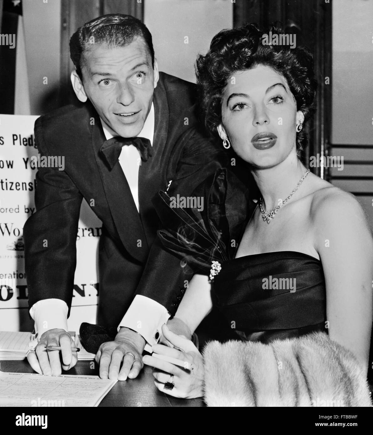 Frank Sinatra and his second wife, Ava Gardner, signing a good citizenship pledge, New York City, NY. Photo by Herman Hiller, c.1952 Stock Photo
