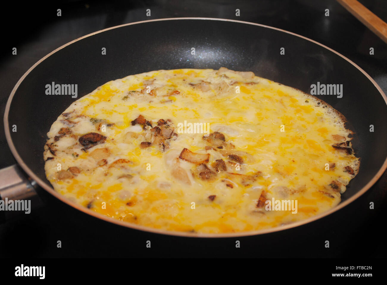 Cooking Scrambled Eggs or an Omelet with Mushrooms & Onions Stock Photo