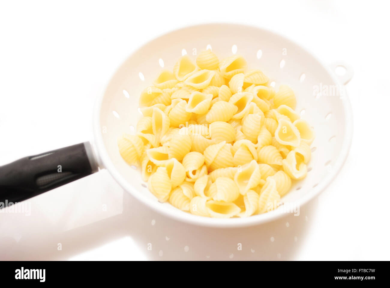 Shell Pasta in a Strainer Stock Photo Alamy