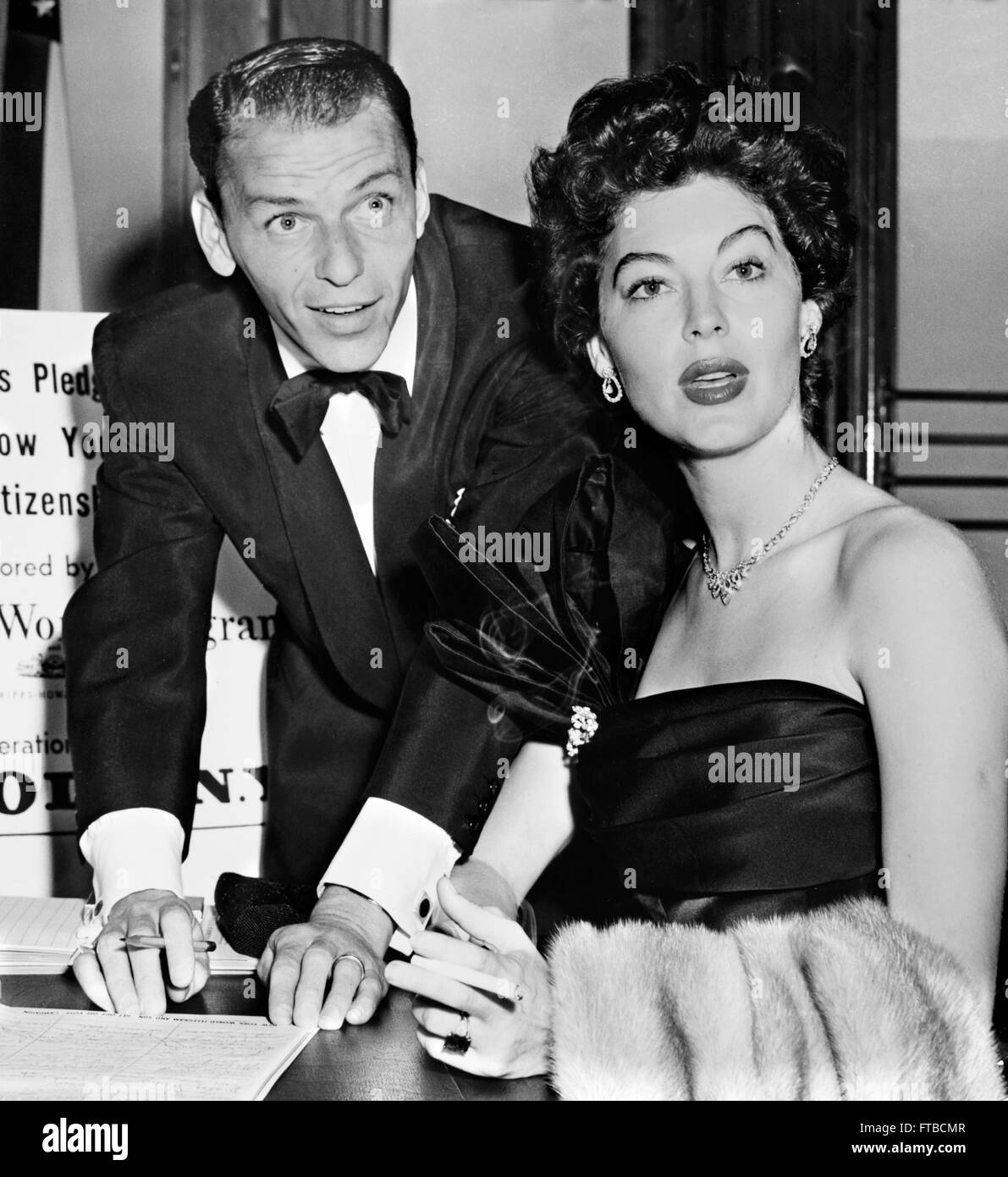 Frank Sinatra and his second wife, Ava Gardner, signing a good citizenship pledge, New York City, NY. Photo by Herman Hiller, c.1952 Stock Photo