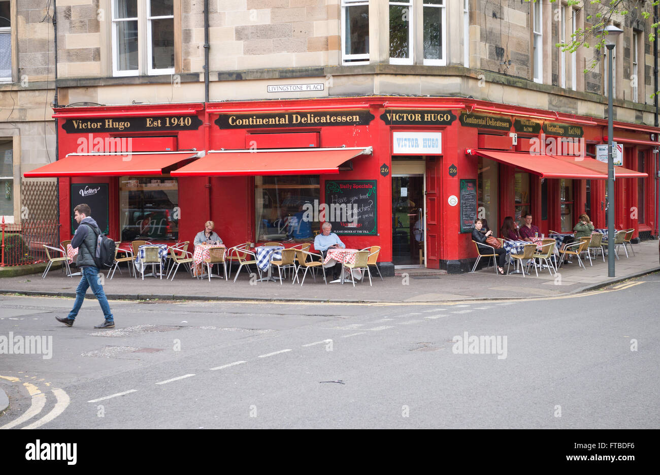 Cafe Culture in Edinburgh. People sit at tables outside Victor Hugo