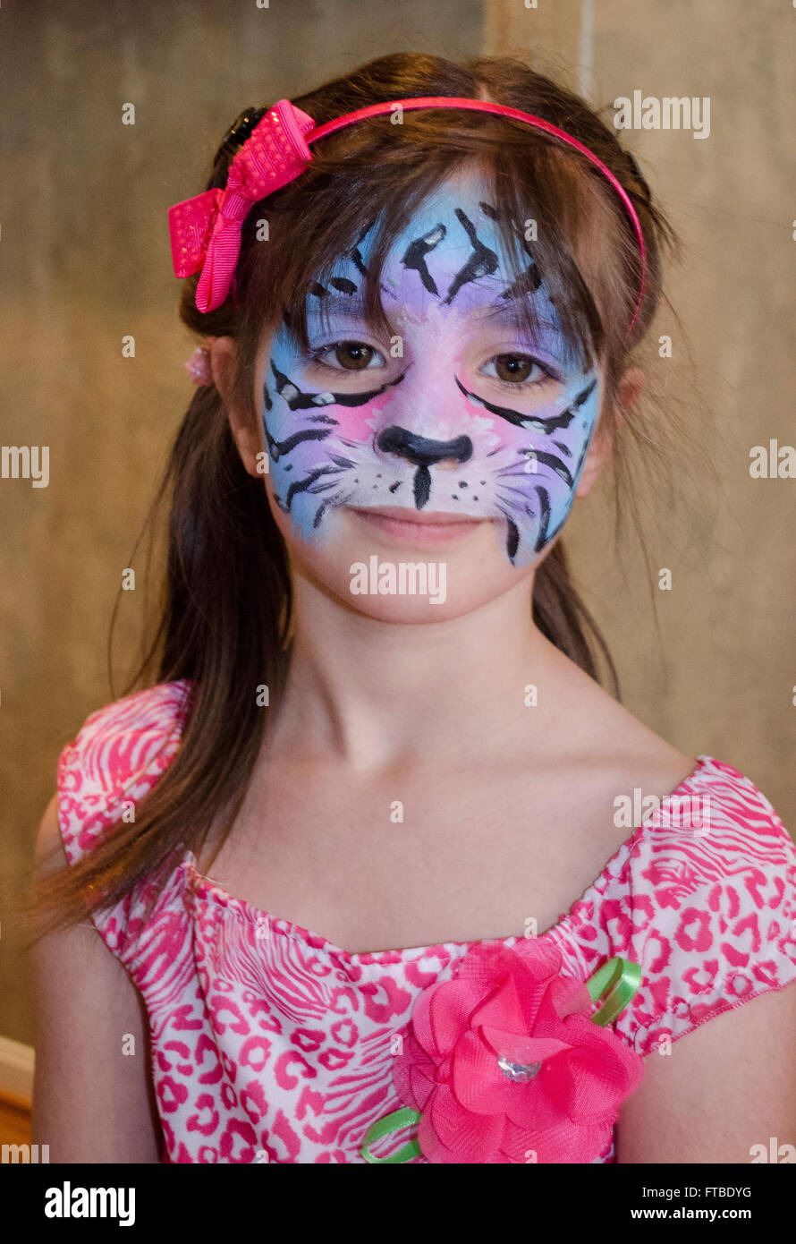 Young girl wearing animal face paint from party Stock Photo