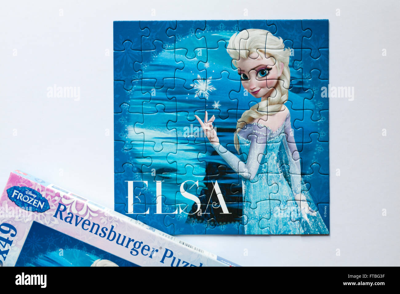 Disney Frozen Ravensburger Puzzle jigsaw puzzle with puzzle of Elsa  character set on white background Stock Photo - Alamy
