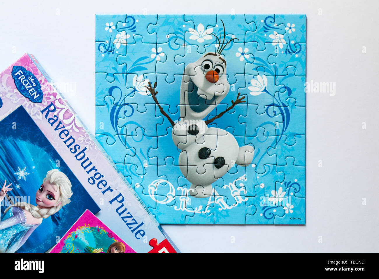 Disney Frozen Ravensburger Puzzle jigsaw puzzle with puzzle of Olaf  character set on white background Stock Photo - Alamy