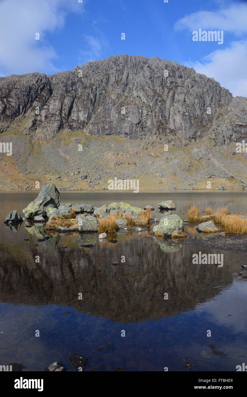 Pavey Ark Reflected in the Calm Waters of Stickle Tarn Langdale,Cumbria UK. Stock Photo