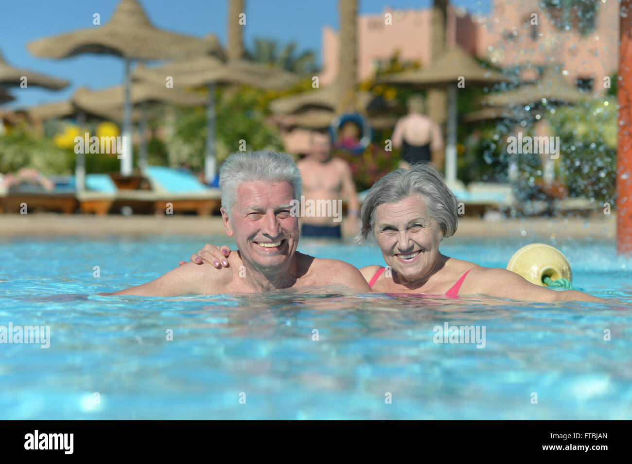 Senior couple relaxing at pool Stock Photo - Alamy