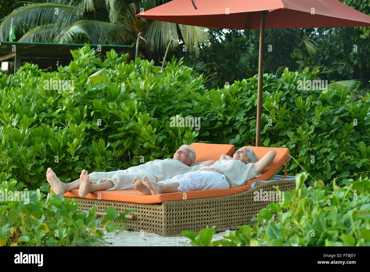 Senior couple relaxing near hotel resort Stock Photo - Alamy